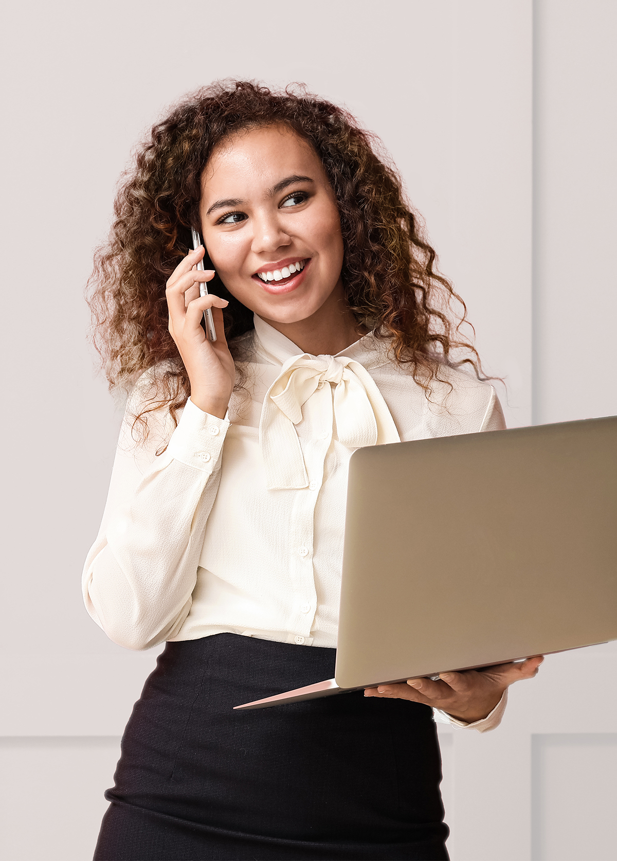 Young businesswoman with laptop talking by phon