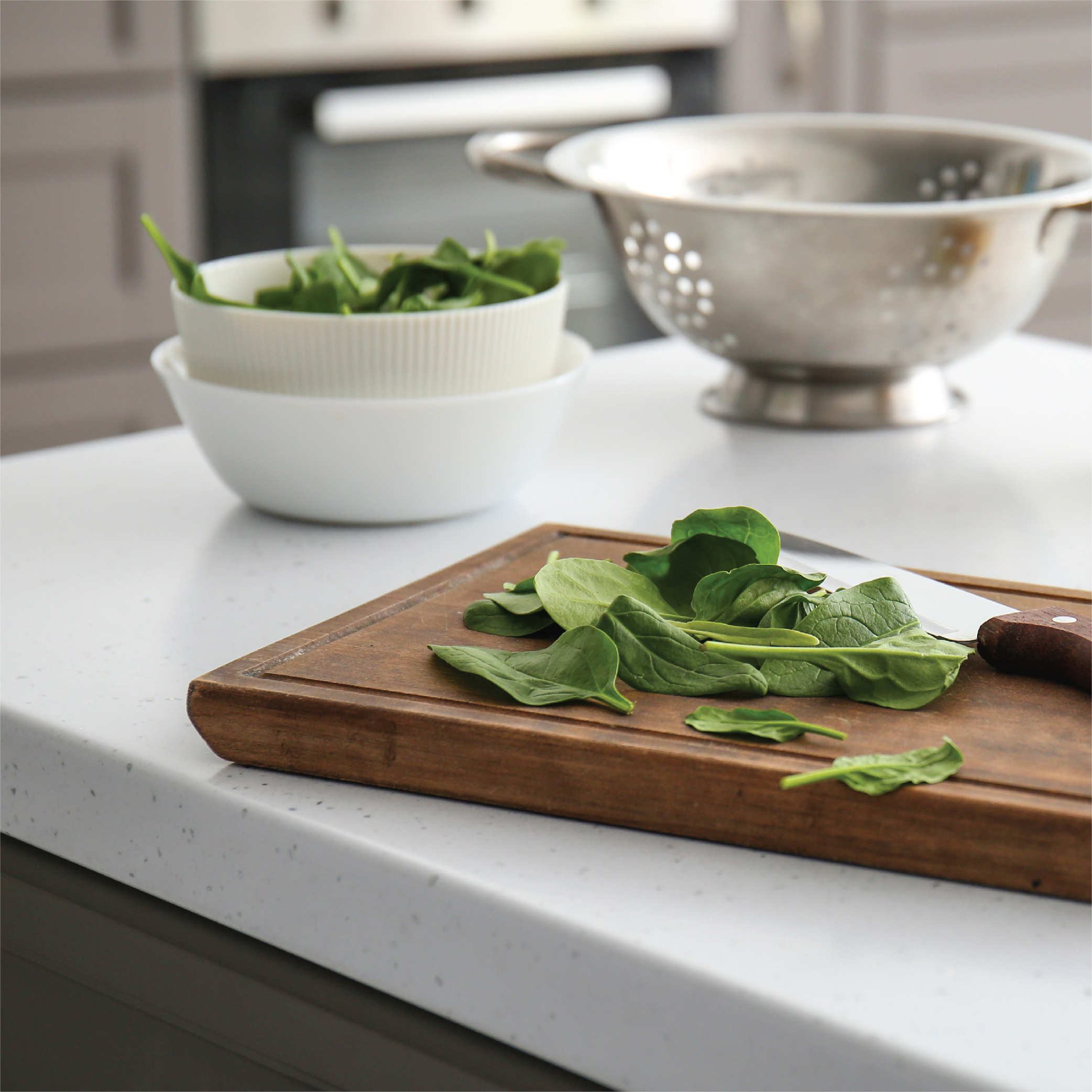 spinach on cutting board in kitchen