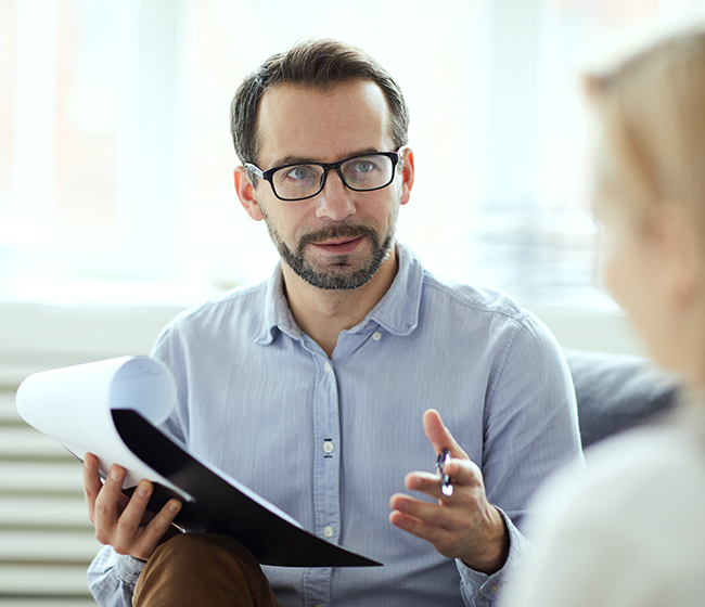 A therapist talking to a patient during a session