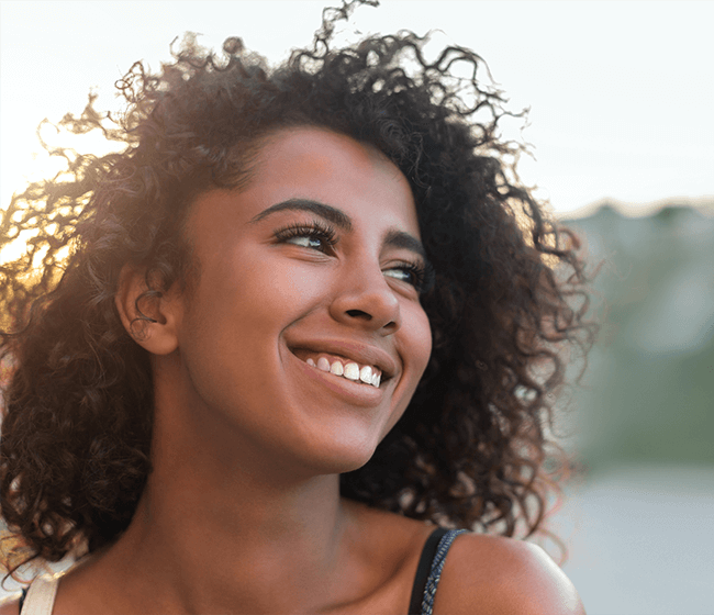 woman smiling during sunset