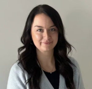 Headshot of Skye Casey wearing a light gray cardigan over a dark shirt