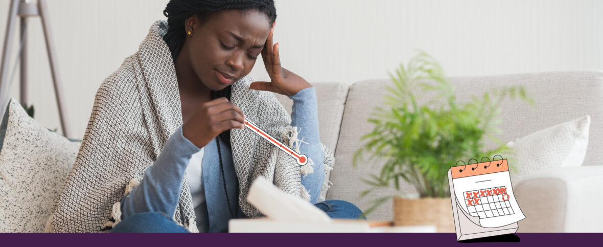 Woman wrapped in a blanket holding a thermometer showing fever.