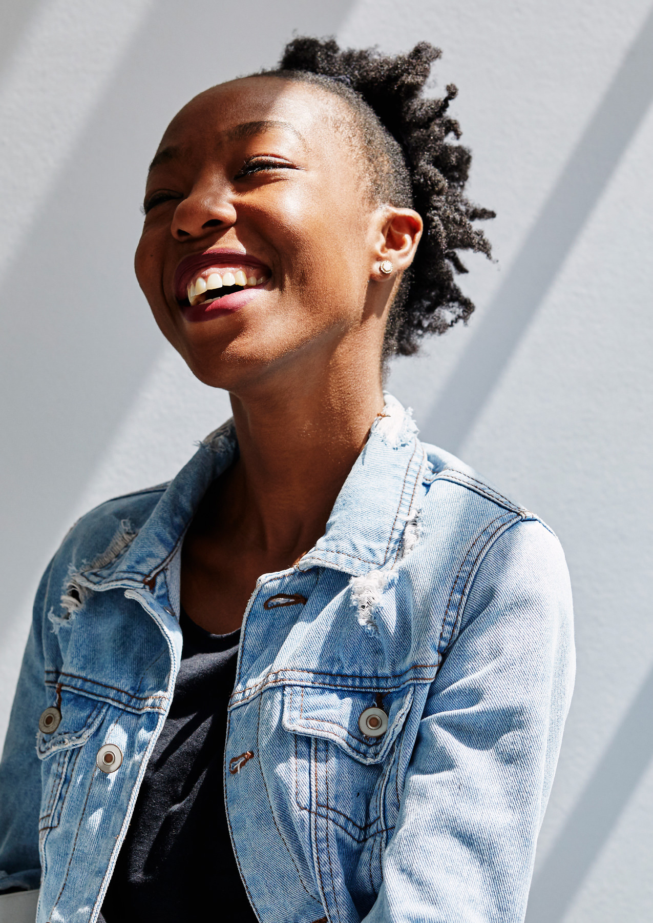 Young woman smiling after talking to a doctor online on Maple