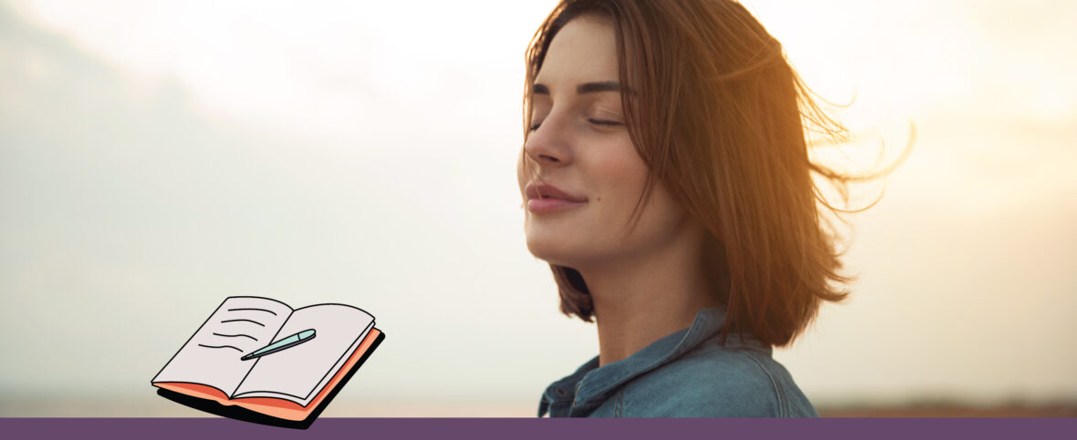 Woman enjoying the sunset with an illustrated journal.