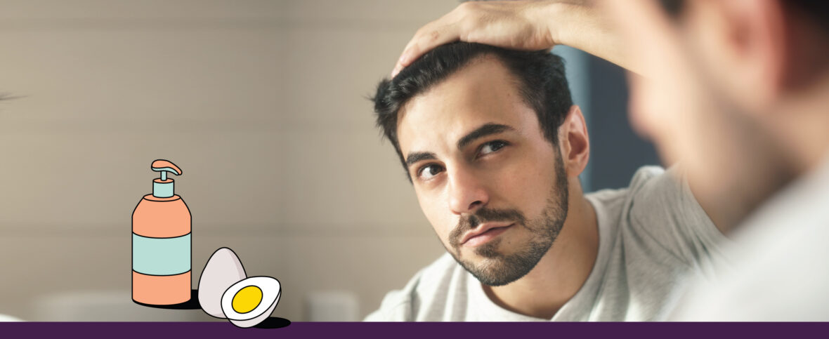 Male concerned about seasonal hair loss looking into a mirror with his hand on his head. Below is an illustrated shampoo bottle and eggs.