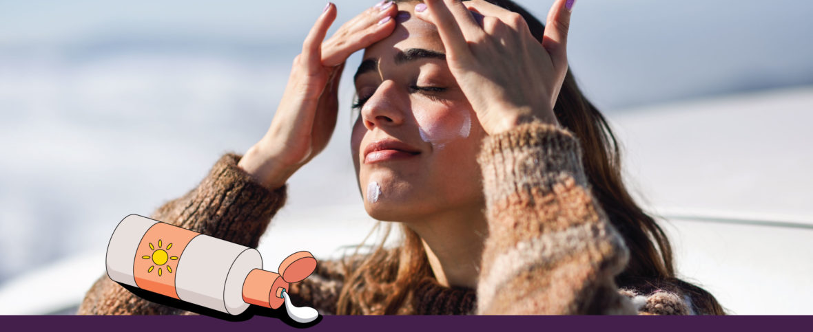 Woman applying sunscreen to her face.