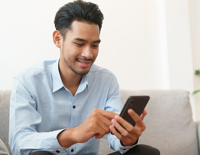 Man looking at his phone during an online doctor consult