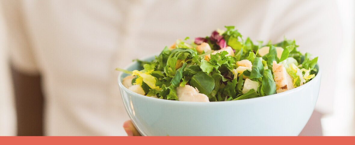 Person holding a bowl of salad to represent healthy habits for the new year.