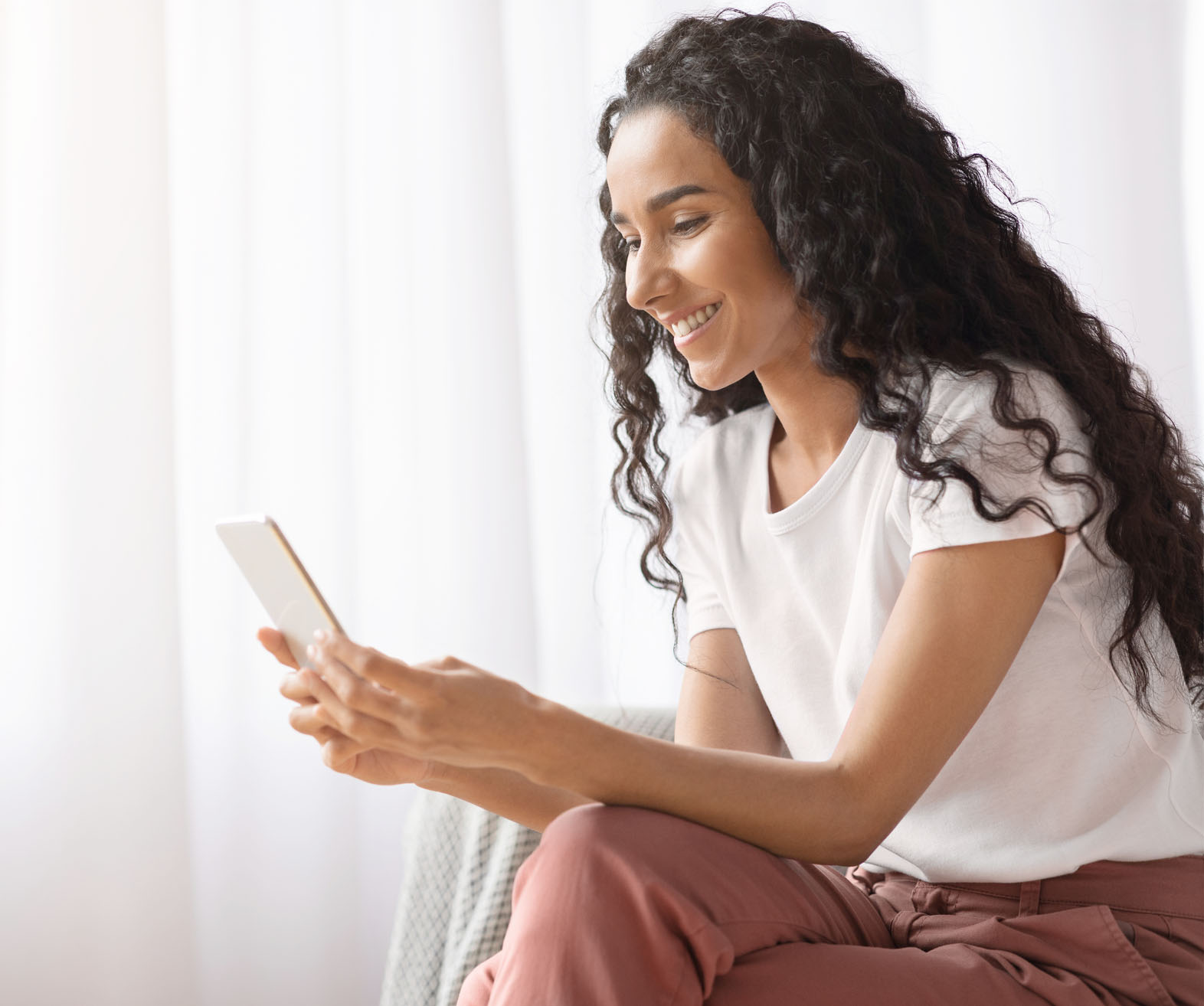 a young woman using her phone for an online consultation