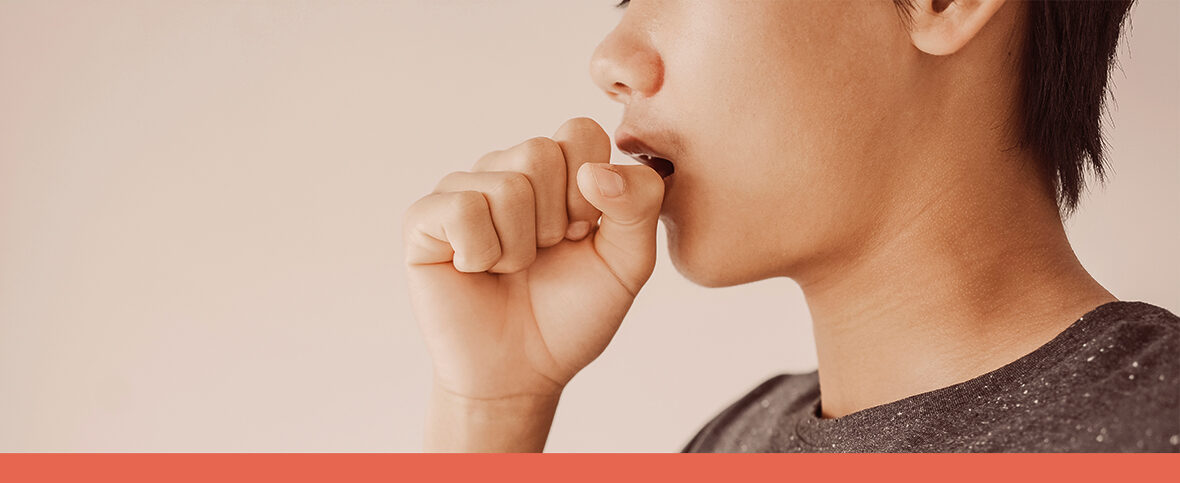 Man experiencing severe coughing covers his mouth with his hand.